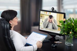psychiatrist with patient performing remote mental health services