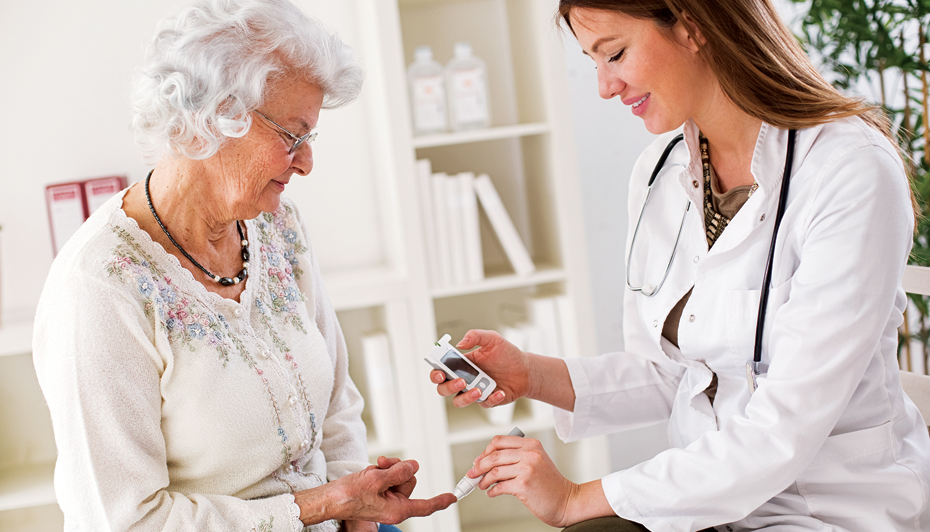 Doctor testing patient blood glucose level
