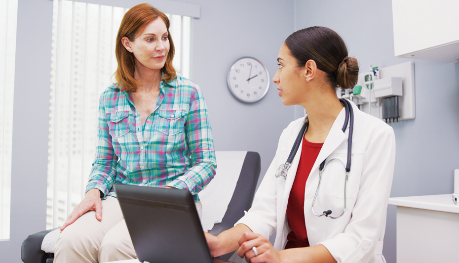 Female doctor consulting with female patient